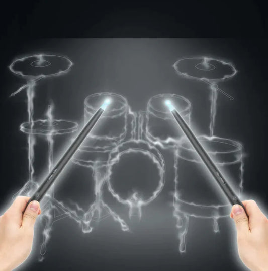 Drum set with glowing sticks held by hands on a dark background