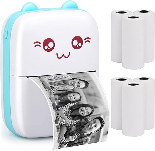Small photo printer with a cute face design, printing a photo of a family, with additional photo paper rolls on a white background.