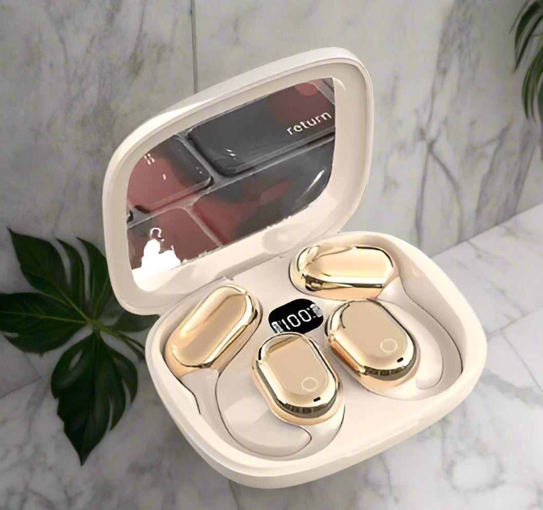 Gold earbud cases in a heart-shaped box on a white background