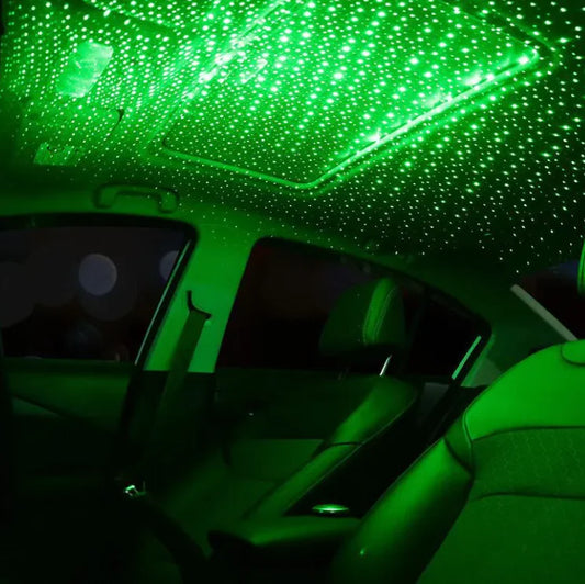 Car interior with green LED lights on the ceiling creating a starry effect.