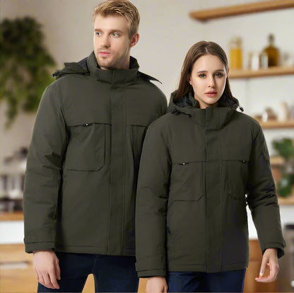 Two people wearing matching green heating jackets on a white background