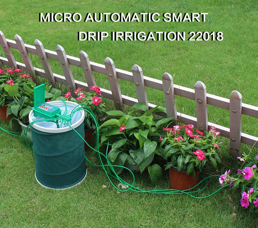 Micro automatic smart drip irrigation system with a green barrel and hose in a garden setting.