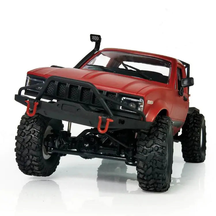 Red off-road model truck with black details on a white background