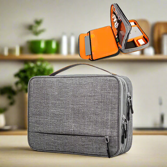 Gray travel portable usb gadget organiser bag with orange interior on a white background