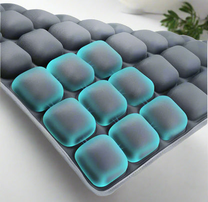 Gray and teal gel pillow with square cooling beads on a white background