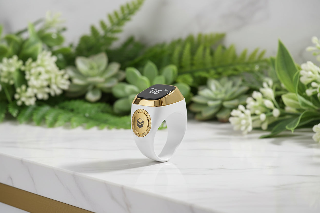 Smart ring with digital display and gold accents on a white background