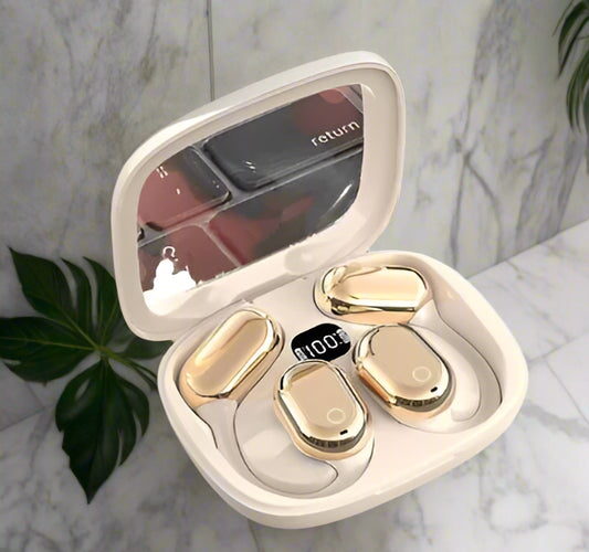 Gold earbud cases in a heart-shaped box on a white background