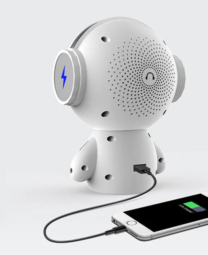 White robot-like device with a phone connected via USB cable on a light gray background