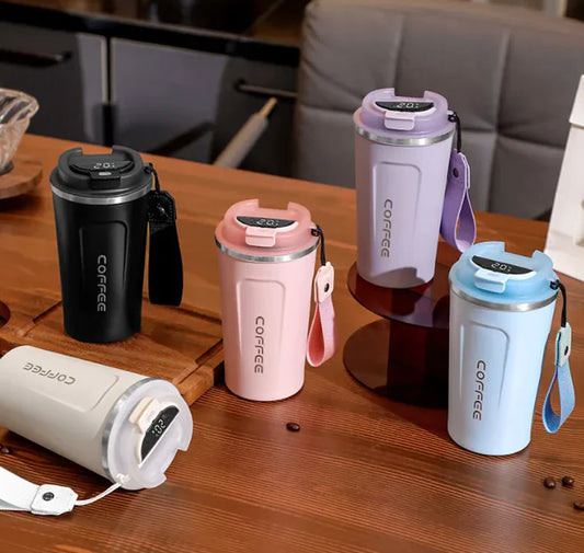 Set of colorful coffee tumblers on a wooden surface with a blurred background