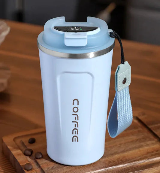 Light blue insulated coffee mug with digital display on a wooden surface