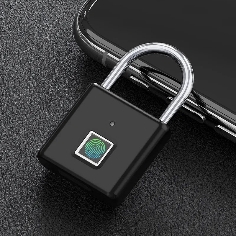 Black electronic lock with fingerprint sensor on a dark textured surface
