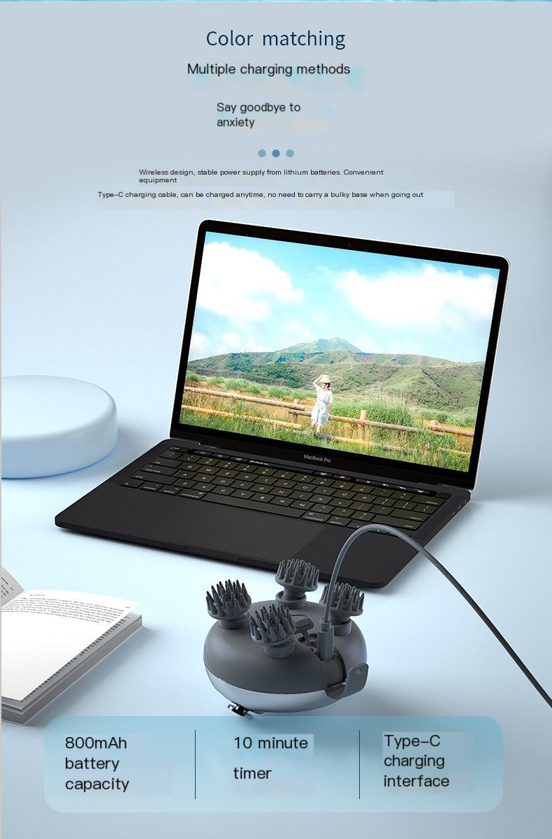 Laptop with a charging device for head massager on a light blue background