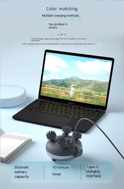 Laptop with a charging device for head massager on a light blue background