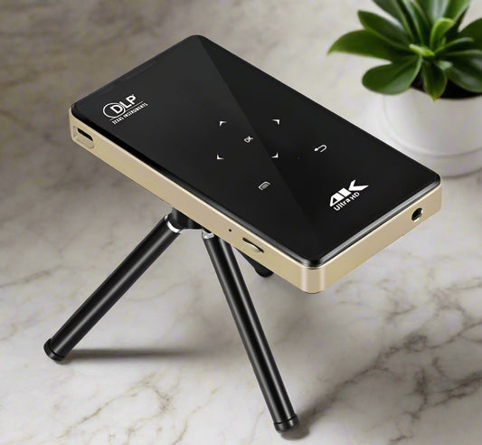 Black and gold electronic device with a tripod stand on a white background