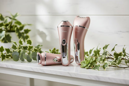 Three rose gold electric shavers on a white background